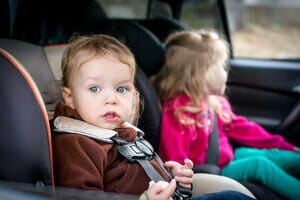 Two children sitting in car | Child Custody