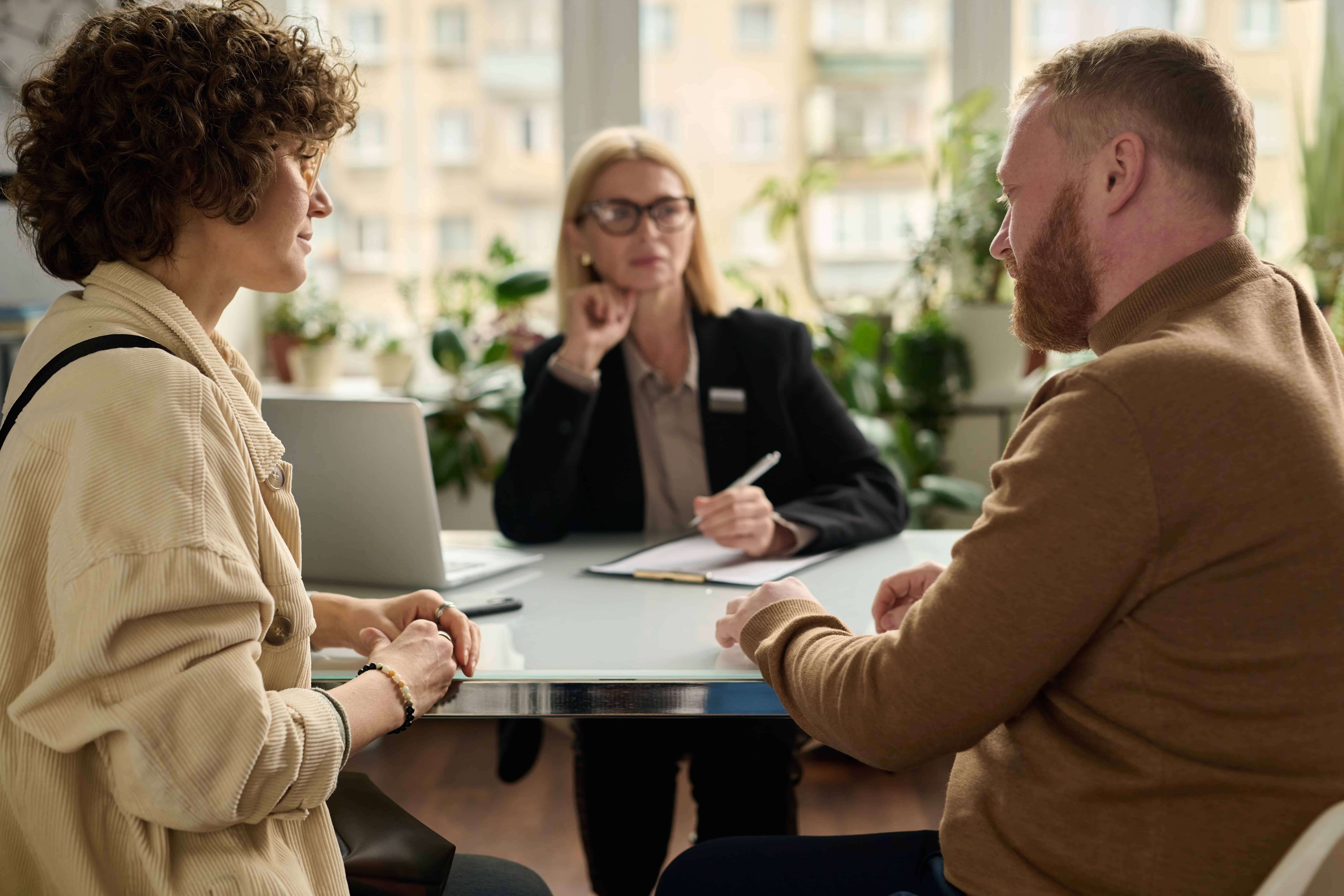 Couple meeting with a lawyer or mediator to discuss legal matters during a professional consultation